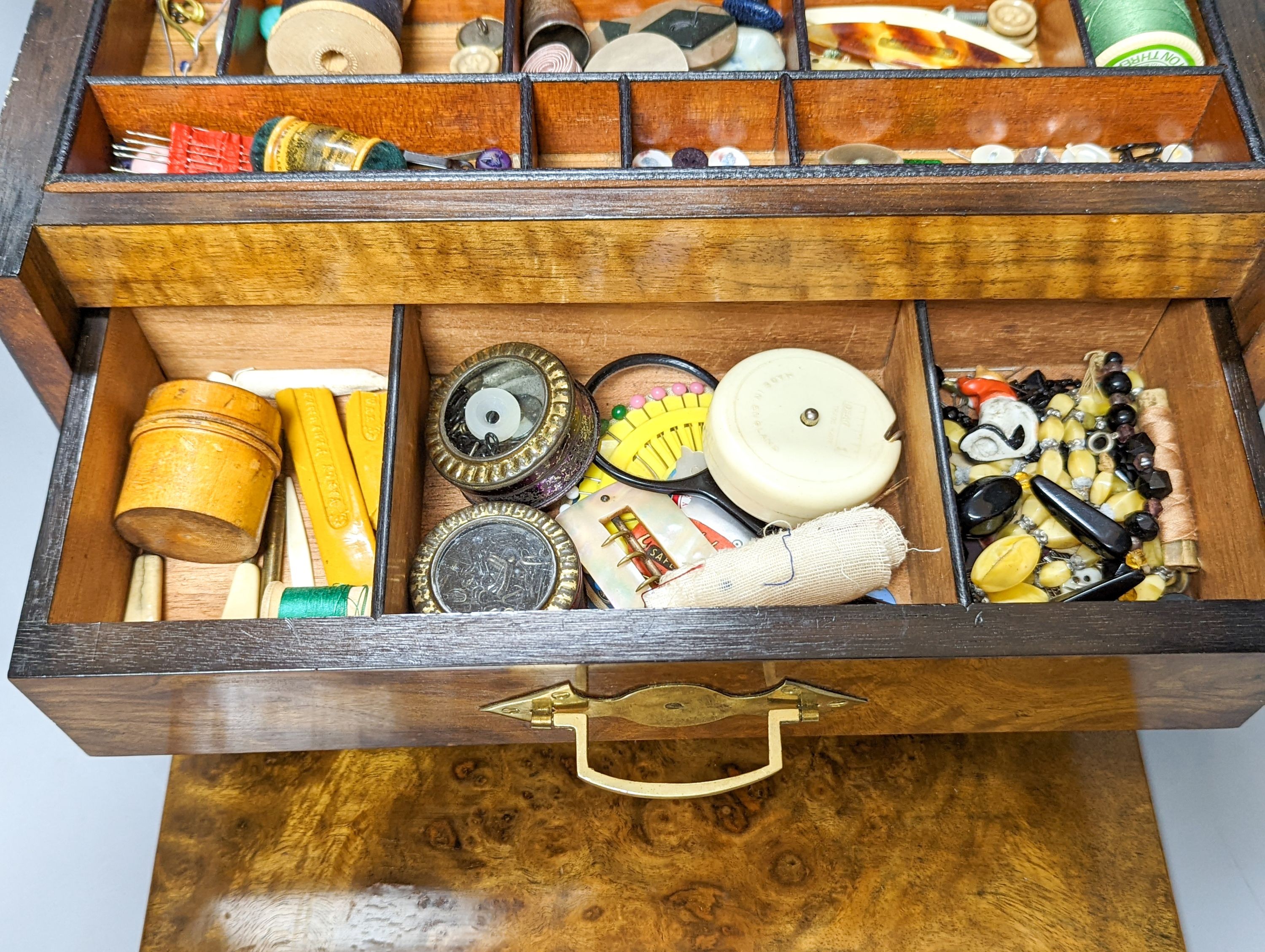 A Victorian walnut sewing casket, 34cm, containing sewing related accessories